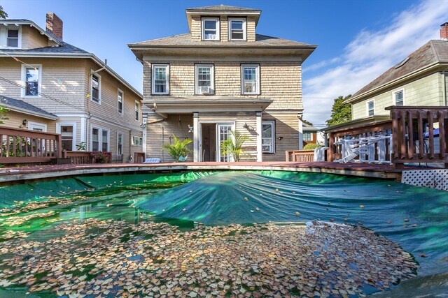 rear view of house featuring a pool side deck