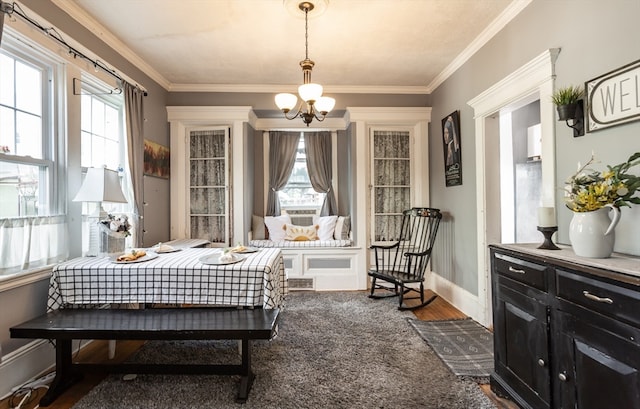 sitting room with ornamental molding, dark hardwood / wood-style flooring, and a notable chandelier