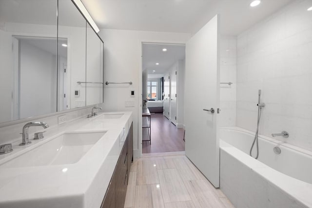 100 Lovejoy Wharf Unit 6J, Boston, MA 02114 - ensuite bathroom featuring recessed lighting, double vanity, and tile patterned floors
