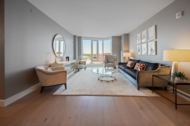 100 Lovejoy Wharf Unit 6J, Boston, MA 02114 - living room featuring wood finished floors, a wall of windows, and baseboards