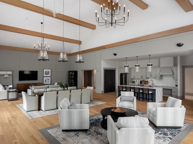 living room with beam ceiling, high vaulted ceiling, and light hardwood / wood-style flooring