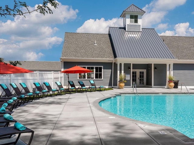 view of swimming pool featuring a patio and french doors