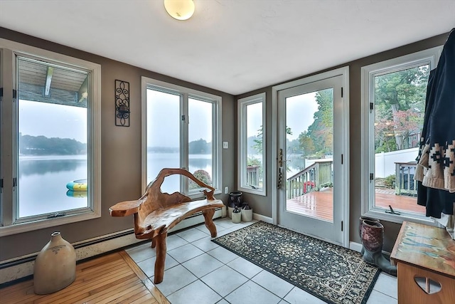 371-377 Franklin St, Wrentham, MA 02093 - doorway to outside featuring light tile patterned floors, a baseboard heating unit, a water view, and baseboards