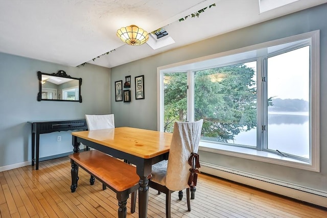 371-377 Franklin St, Wrentham, MA 02093 - dining room featuring a baseboard radiator, light wood finished floors, plenty of natural light, and a skylight