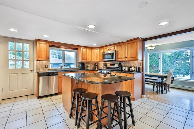371-377 Franklin St, Wrentham, MA 02093 - kitchen with stainless steel appliances, light tile patterned floors, healthy amount of natural light, backsplash, and recessed lighting