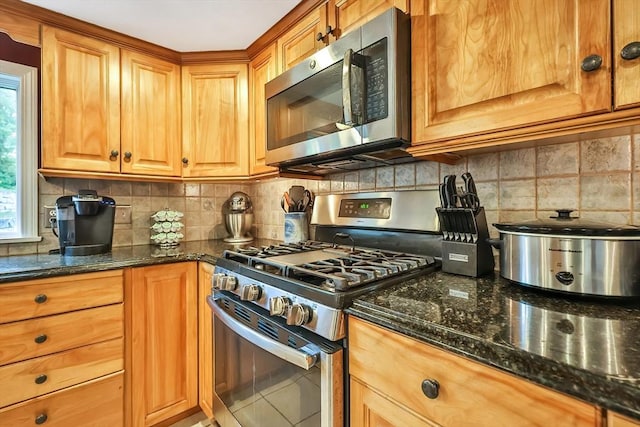 371-377 Franklin St, Wrentham, MA 02093 - kitchen featuring stainless steel appliances, decorative backsplash, dark stone counters, and brown cabinets