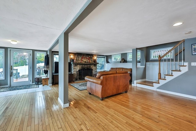 371-377 Franklin St, Wrentham, MA 02093 - living room featuring light wood-style floors, a fireplace, baseboards, and plenty of natural light
