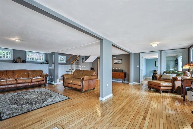 371-377 Franklin St, Wrentham, MA 02093 - living area with light wood finished floors, stairway, baseboards, and a baseboard heating unit