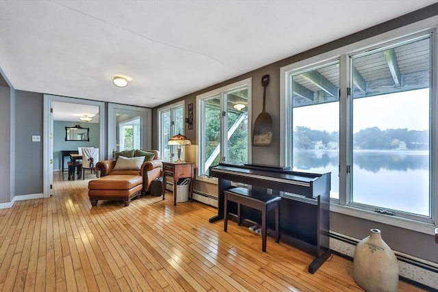 371-377 Franklin St, Wrentham, MA 02093 - living area with baseboard heating, light wood-style floors, a water view, and baseboards