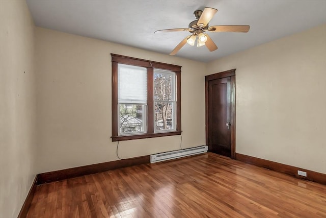 unfurnished room with ceiling fan, baseboard heating, and light hardwood / wood-style flooring