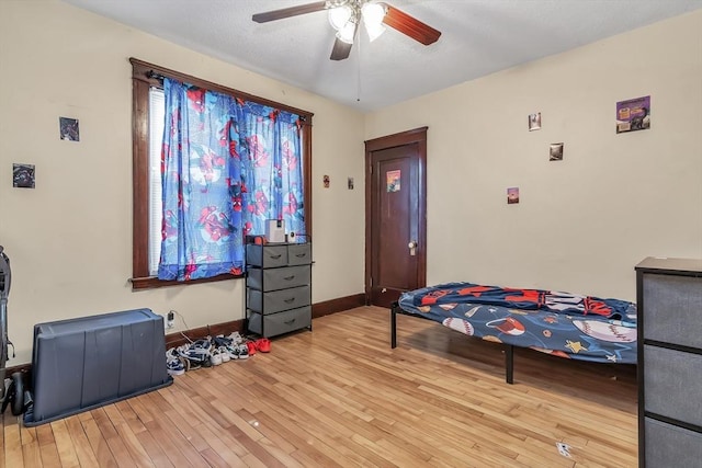 bedroom featuring light wood-type flooring and ceiling fan