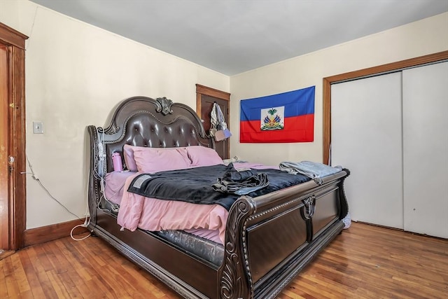 bedroom with wood-type flooring and a closet