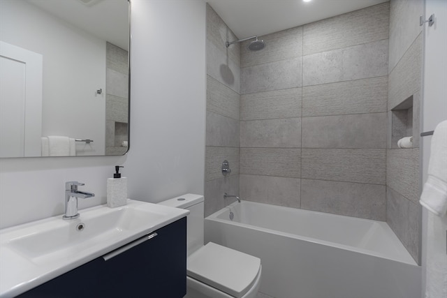 full bathroom featuring vanity, tiled shower / bath combo, and toilet