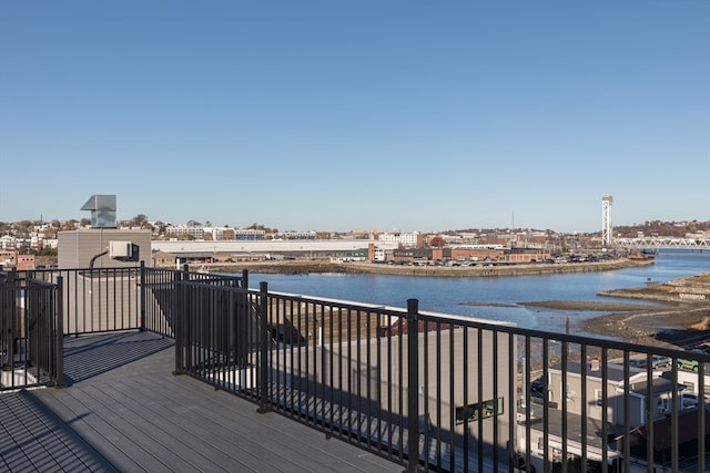 wooden terrace featuring a water view