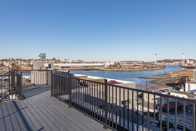 wooden terrace featuring a water view