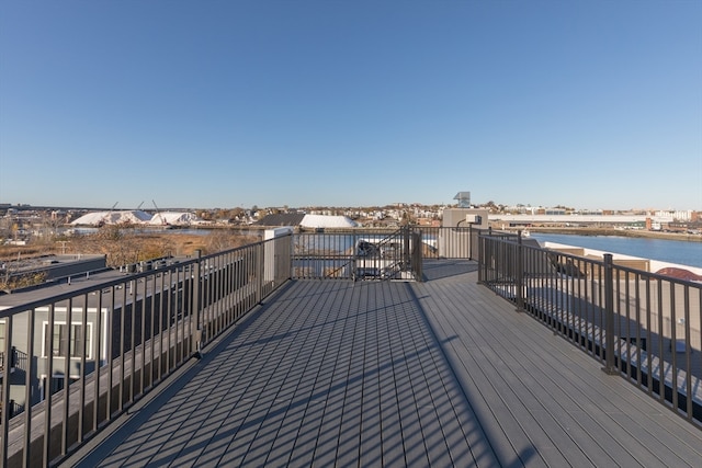 wooden terrace featuring a water view