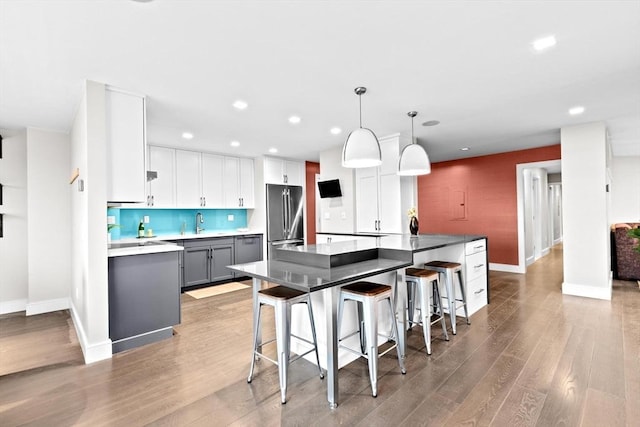 50 Longwood Ave Unit 1016/1017, Brookline, MA 02446 - kitchen with stainless steel refrigerator, recessed lighting, baseboards, light wood-style flooring, and a kitchen breakfast bar