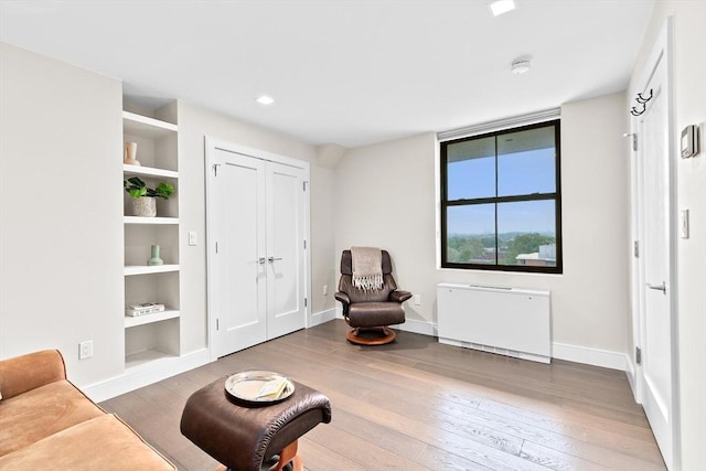 50 Longwood Ave Unit 1016/1017, Brookline, MA 02446 - living area featuring built in shelves, wood-type flooring, baseboards, and recessed lighting