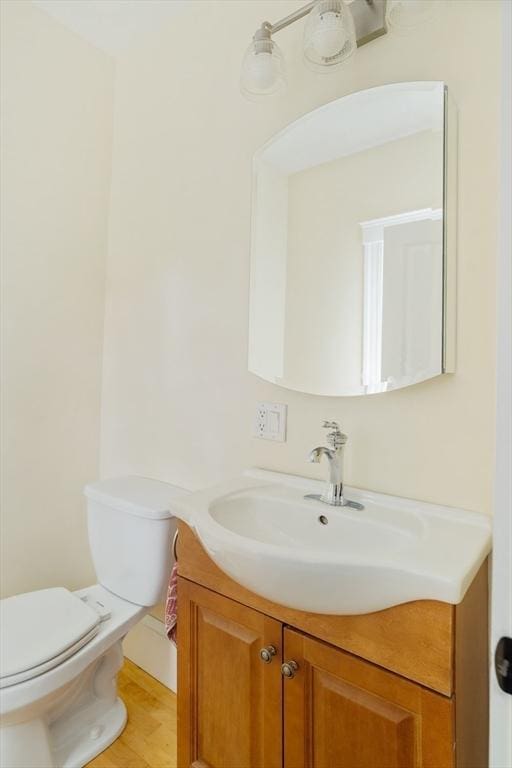 15 Berkeley St, Somerville, MA 02143 - half bath featuring vanity and wood finished floors