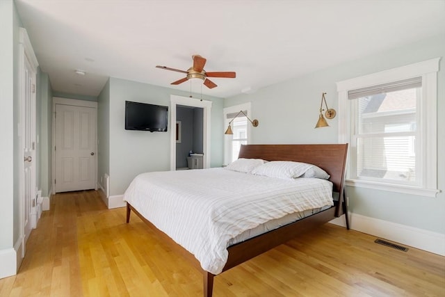 15 Berkeley St, Somerville, MA 02143 - bedroom with light wood finished floors, multiple windows, and a ceiling fan