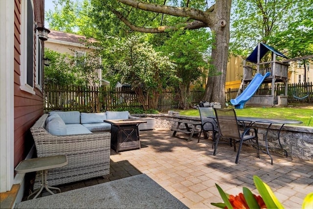 15 Berkeley St, Somerville, MA 02143 - fenced backyard with a patio, a playground, an outdoor living space with a fire pit, and outdoor dining space
