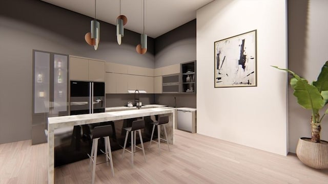 kitchen with black refrigerator with ice dispenser, light hardwood / wood-style floors, pendant lighting, and a breakfast bar area