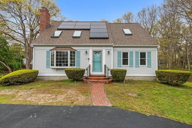 22 Woodside Dr, Falmouth, MA 02536 - view of front of property featuring a chimney, roof mounted solar panels, a front lawn, and a shingled roof