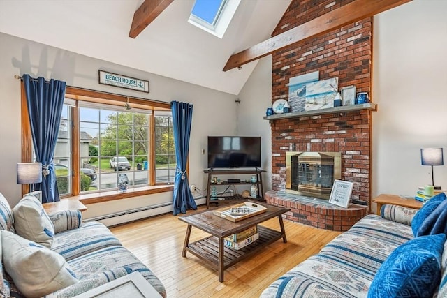 22 Woodside Dr, Falmouth, MA 02536 - living area with a baseboard heating unit, beamed ceiling, a skylight, wood finished floors, and a fireplace