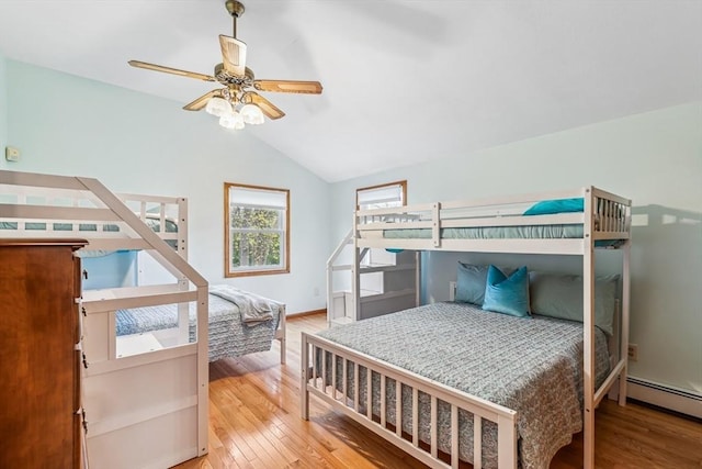 22 Woodside Dr, Falmouth, MA 02536 - bedroom featuring wood finished floors, a baseboard radiator, lofted ceiling, and a ceiling fan