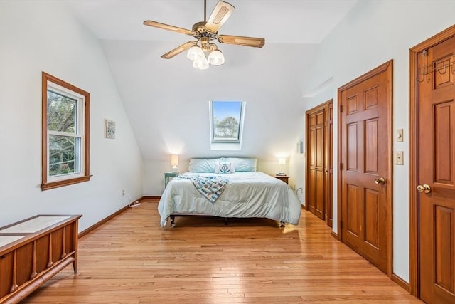 22 Woodside Dr, Falmouth, MA 02536 - bedroom featuring vaulted ceiling, light wood-type flooring, a ceiling fan, a skylight, and baseboards