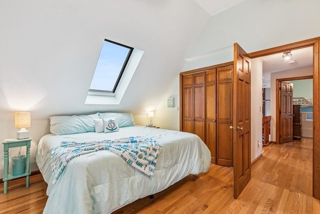 22 Woodside Dr, Falmouth, MA 02536 - bedroom with a skylight, lofted ceiling, light wood-style flooring, and a closet