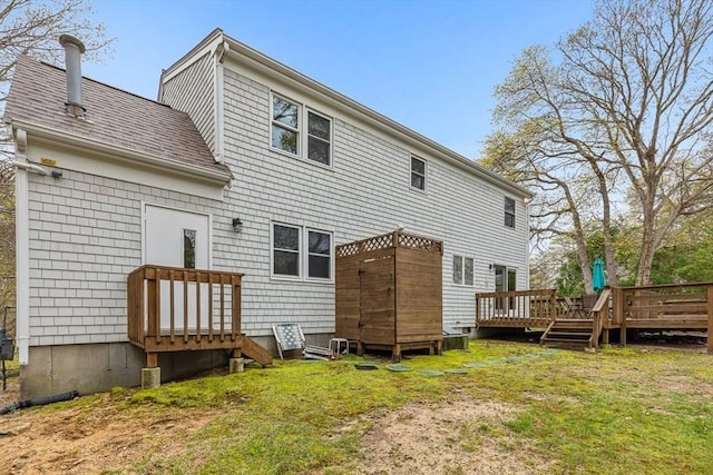 22 Woodside Dr, Falmouth, MA 02536 - rear view of property featuring a deck, a yard, and roof with shingles