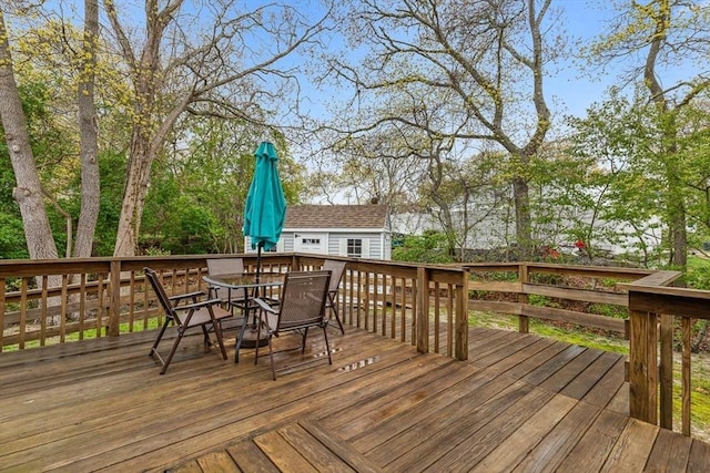 22 Woodside Dr, Falmouth, MA 02536 - wooden deck with outdoor dining area and an outbuilding