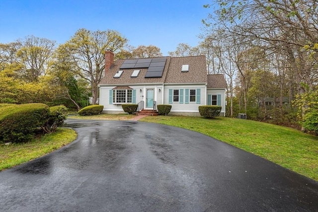 22 Woodside Dr, Falmouth, MA 02536 - view of front of property featuring driveway, roof mounted solar panels, a front yard, a chimney, and roof with shingles
