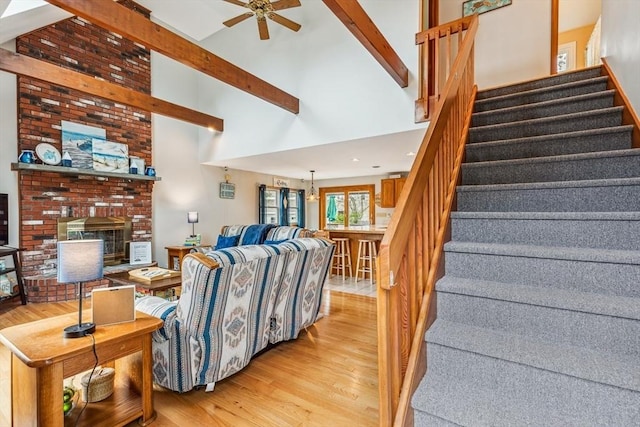 22 Woodside Dr, Falmouth, MA 02536 - living area featuring light wood-style flooring, stairway, beam ceiling, high vaulted ceiling, and a ceiling fan