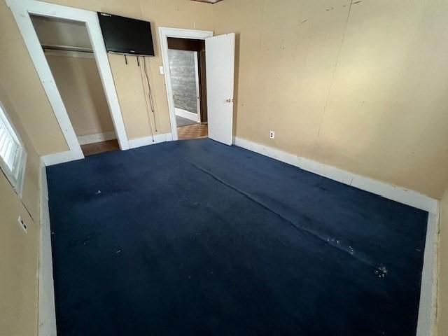 14 Felton St, Fitchburg, MA 01420 - unfurnished bedroom featuring two closets and dark colored carpet