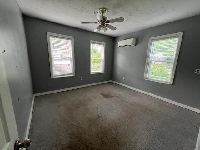14 Felton St, Fitchburg, MA 01420 - carpeted spare room featuring a wall mounted AC, healthy amount of natural light, and a ceiling fan