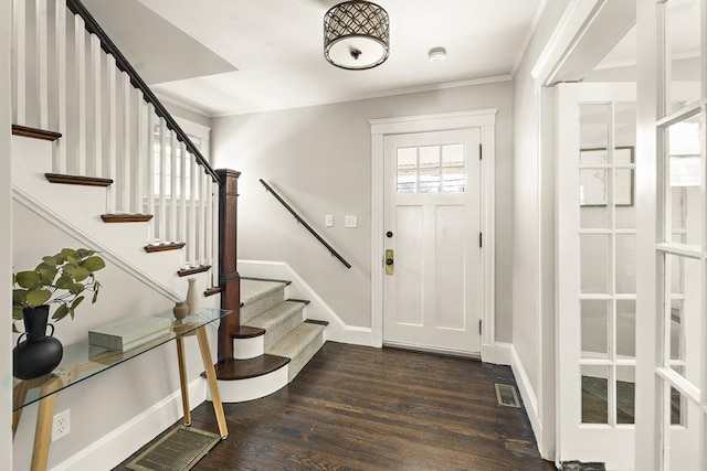 foyer entrance with dark hardwood / wood-style flooring, crown molding, and plenty of natural light