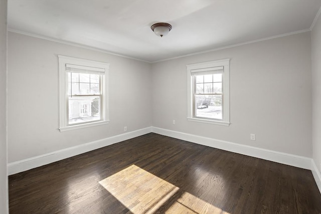 spare room featuring ornamental molding, a healthy amount of sunlight, and dark hardwood / wood-style floors