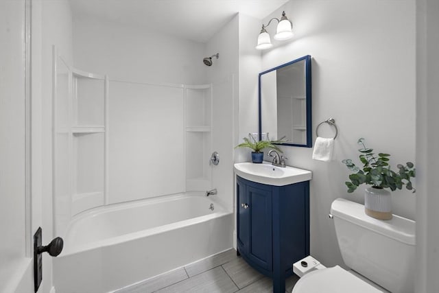 full bathroom featuring washtub / shower combination, vanity, and toilet