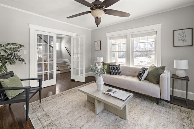 living room featuring crown molding, dark hardwood / wood-style floors, ceiling fan, and french doors