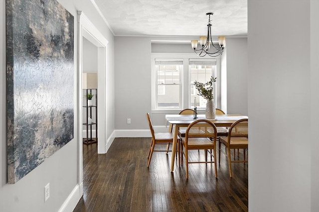 dining space featuring a notable chandelier and dark hardwood / wood-style flooring