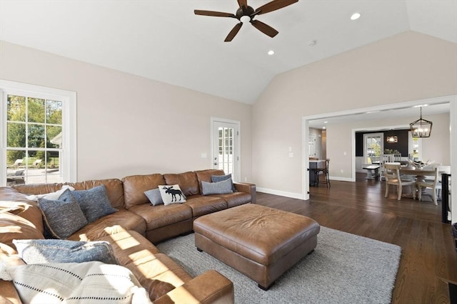living area featuring lofted ceiling, a ceiling fan, wood finished floors, baseboards, and recessed lighting