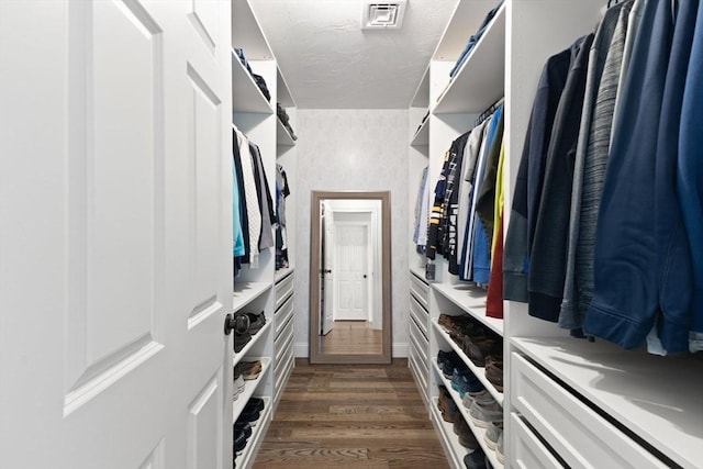 walk in closet featuring dark wood-style flooring
