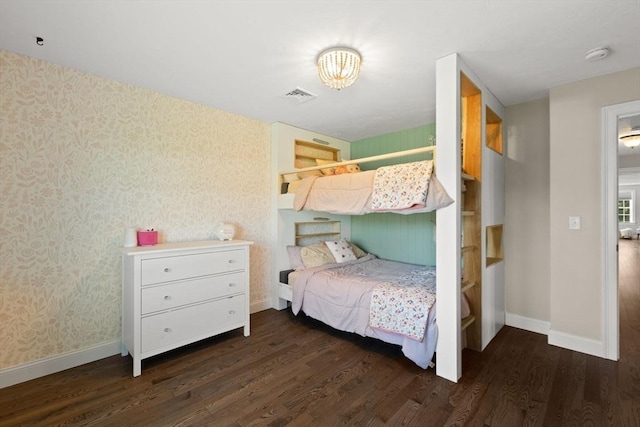 bedroom featuring wallpapered walls, wood finished floors, baseboards, and a chandelier