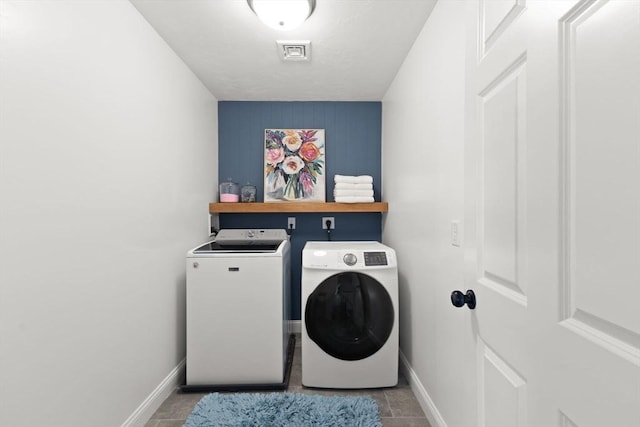 laundry room with washing machine and clothes dryer and baseboards