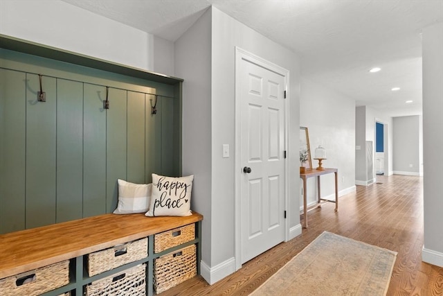 mudroom featuring baseboards, light wood finished floors, and recessed lighting