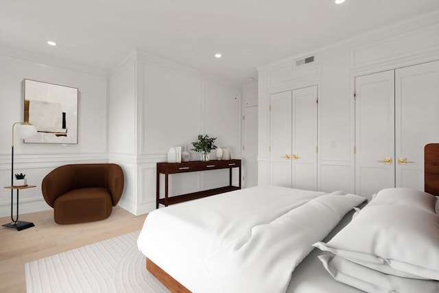 9 Russell Unit 1, Boston, MA 02129 - bedroom with a decorative wall, ornamental molding, wood finished floors, multiple closets, and recessed lighting