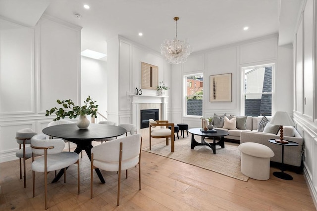 9 Russell Unit 1, Boston, MA 02129 - dining area featuring a decorative wall, a glass covered fireplace, light wood finished floors, a chandelier, and recessed lighting