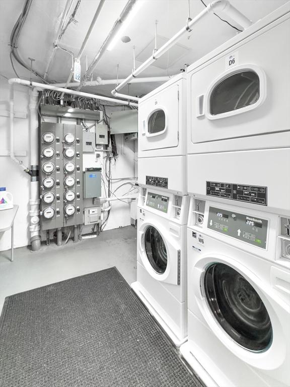 laundry room with stacked washer / drying machine and washer and dryer